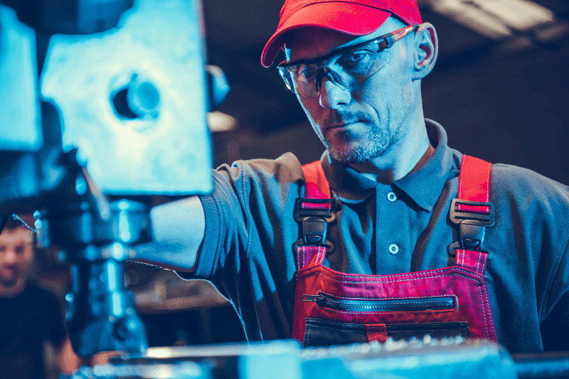 worker cutting wood on a cnc machine